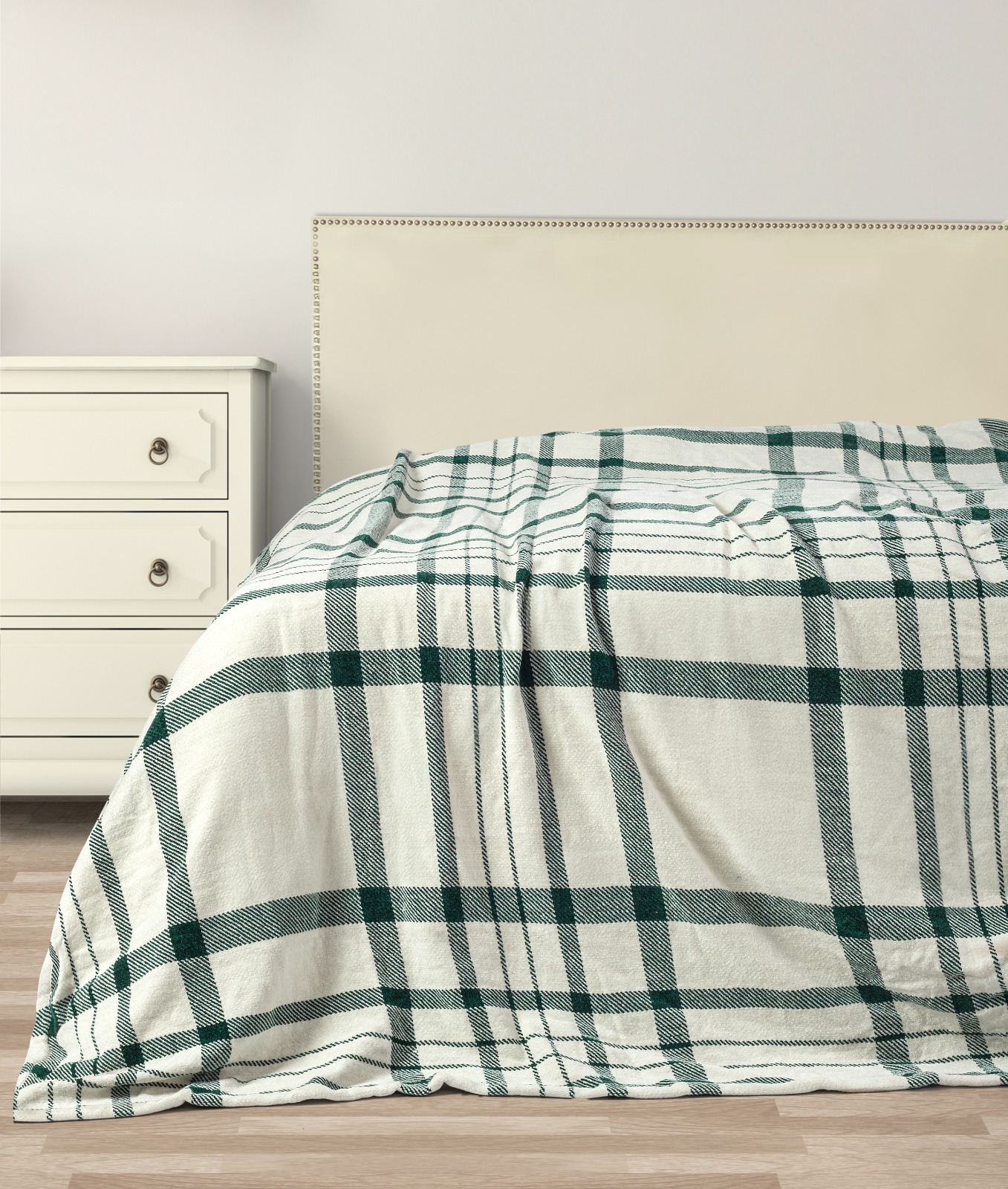 Green plaid winter throw on a bed