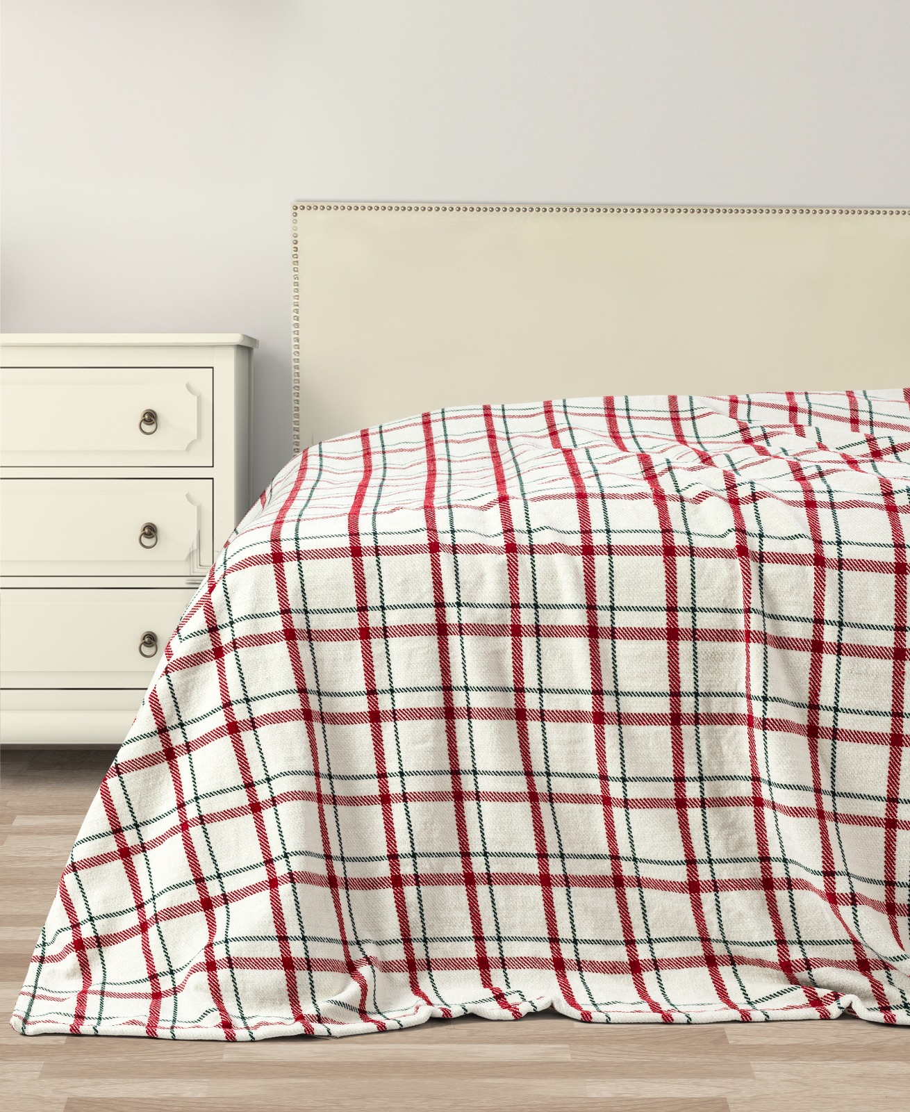 Red and green plaid winter throw on a bed