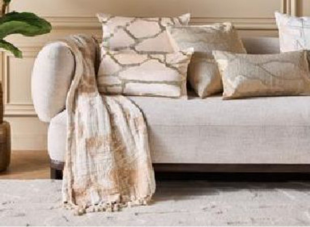Si Home cushions and throw styled on a sofa